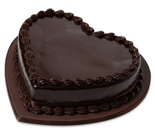 Heart-shaped chocolate cake with glossy glaze and decorative piping on a brown board.
