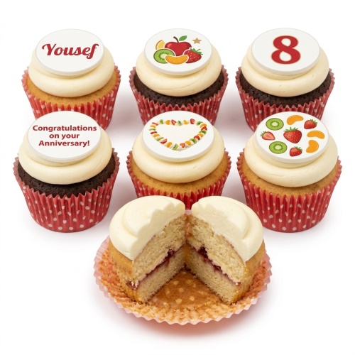 Heart-shaped cupcakes with white icing, topped with fresh strawberries, kiwi, and mandarin segments.