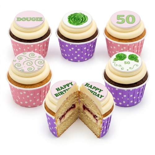 Assortment of floral and swirl birthday cupcakes with custom age and name toppers in pink and purple cases.