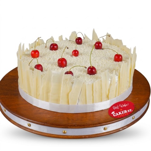 Round white chocolate and cherry birthday cake with white chocolate shards