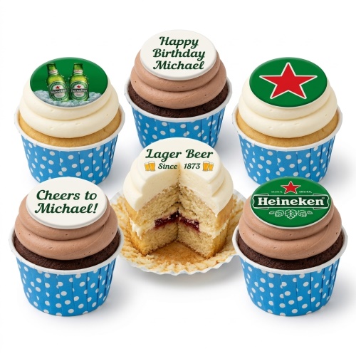 Selection of cupcakes with Heineken themed edible toppers, some with vanilla and some with chocolate frosting, in blue polka dot wrappers.