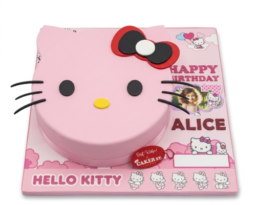 Pink Hello Kitty head birthday cake with a custom photo, name, and age topper.