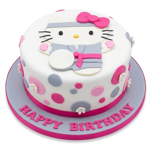 Round white Hello Kitty birthday cake with pink bow, grey and pink polka dots, and white flowers.