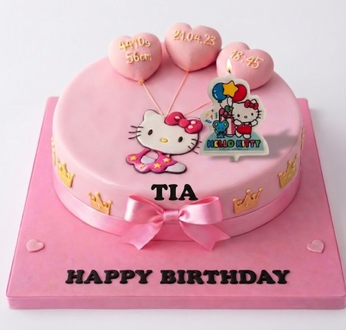 Round pink Hello Kitty birthday cake with gold crowns, pink bow, and heart toppers.