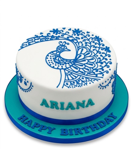 Round white birthday cake with blue piped peacock design and personalised message.