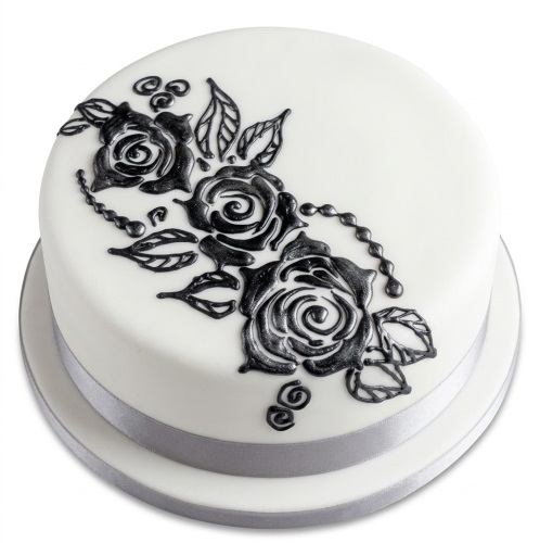 Round white cake with metallic silver rose and leaf decorations, and a silver ribbon.