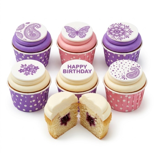Six decorative cupcakes with purple and pink frosting, topped with white edible discs featuring floral, butterfly, and paisley patterns. One disc says "Happy Birthday".