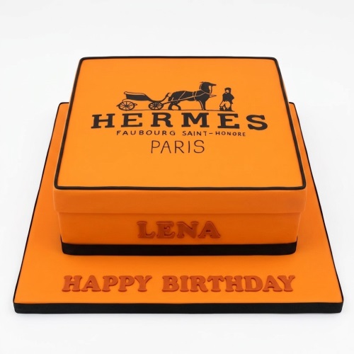 Orange Hermes designer gift box style birthday cake with black trim and logo, featuring a custom name and 'Happy Birthday' message.