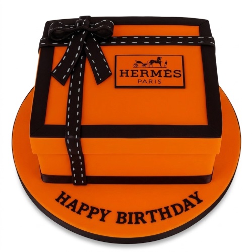 Orange Hermes gift box birthday cake with brown ribbon and 'Happy Birthday' message