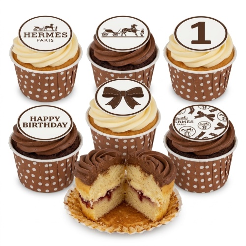 Brown and cream cupcakes with Hermes Paris logos, horse carriage, bow, and number 1 toppers.