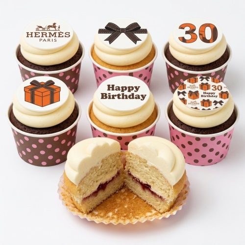 Luxury birthday cupcakes with designer-inspired bows, gift boxes, and custom age toppers