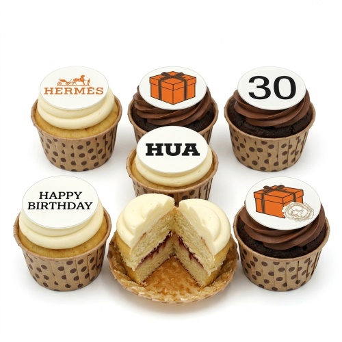 Hermes logo, orange gift box, and 'Happy Birthday' toppers on vanilla and chocolate cupcakes with polka dot cases.