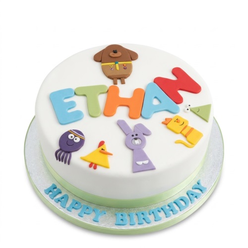 Round white Hey Duggee birthday cake with colourful characters and a custom name