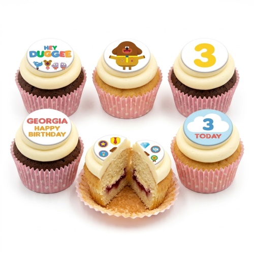 Set of Hey Duggee themed cupcakes with white frosting and pink wrappers, featuring character toppers and a custom age topper.