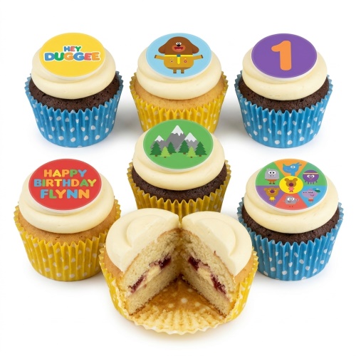 Collection of Hey Duggee themed cupcakes with character toppers, mountain design, custom age topper, and personalised message example.