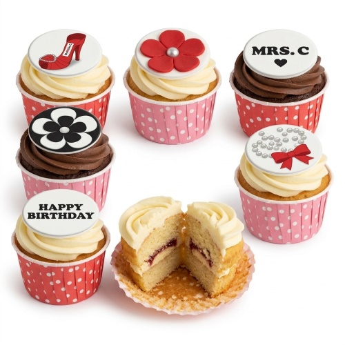 Selection of elegant ladies birthday cupcakes with high heel, flower, pearl, and Happy Birthday toppers.
