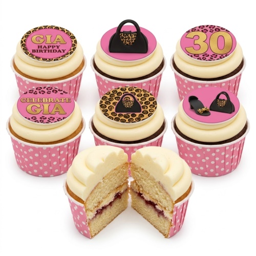 White and cream cupcakes with pink polka dot wrappers, topped with fashion and leopard print designs, including handbags, high heels, and custom age/name elements.