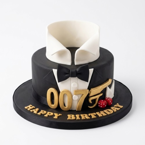 Black tuxedo themed birthday cake with white collar, black bow tie, gold 007, pistol, and red dice.