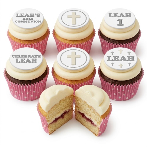 White frosted cupcakes with cross and personalised message toppers in pink wrappers.