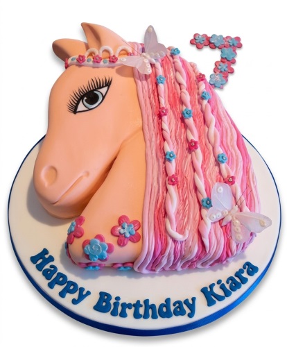 Sculpted horse head birthday cake with pink braided mane, flowers, butterflies, and a custom age topper.