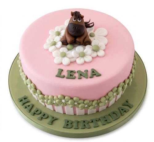 Pink round birthday cake with a brown fondant horse topper, white and green daisies, and a green 'Happy Birthday' message.