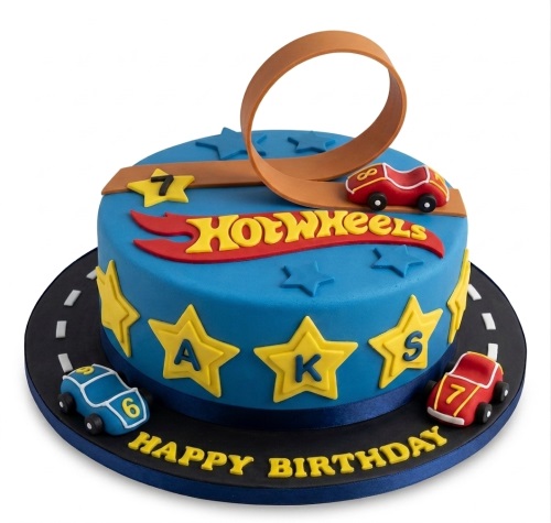Blue Hot Wheels birthday cake with racing cars, track loop, stars, and custom age.