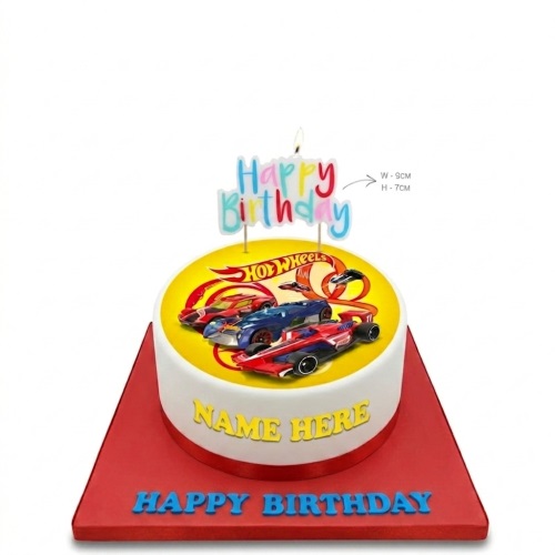 Round white Hot Wheels birthday cake with racing cars, yellow top, and a 'Happy Birthday' candle.