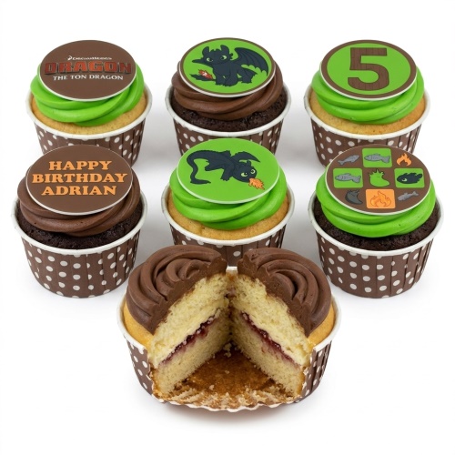 How to Train Your Dragon cupcakes with Toothless toppers, green and brown frosting, and custom age.