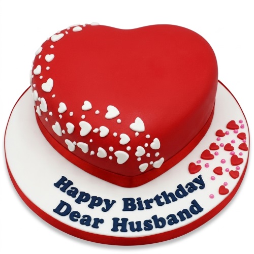 Red heart-shaped birthday cake with white hearts and a custom message.