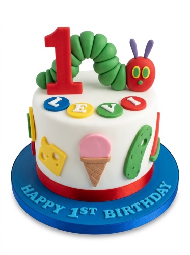 White 1st birthday cake with The Very Hungry Caterpillar, number 1, and food decorations.
