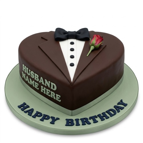 Heart-shaped brown tuxedo cake with white shirt, black bow tie, red rose, and 'Happy Birthday' message.