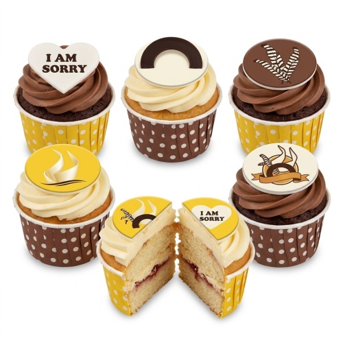 Six cupcakes with chocolate and vanilla frosting, yellow and brown polka dot cases, and edible toppers including a heart with 'I AM SORRY' text.