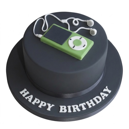 Dark grey round birthday cake with a lime green music player and white earphones on top, with 'Happy Birthday' written on the board.