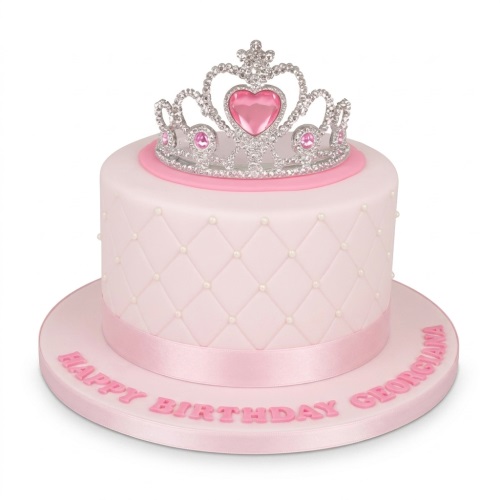 Pink quilted birthday cake with white pearls, topped with a silver and pink tiara, and a personalised message.