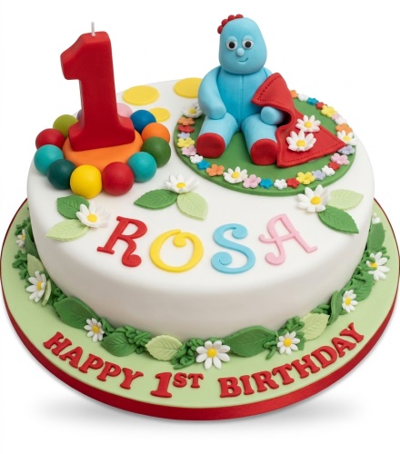 Round white Igglepiggle In The Night Garden 1st birthday cake with a red number one candle and personalised name.