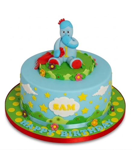 Light blue In The Night Garden Igglepiggle 1st birthday cake with stars and clouds.