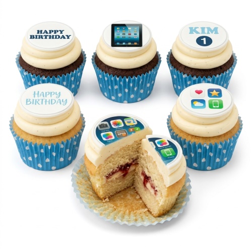 Selection of cupcakes with white frosting and blue polka dot wrappers, featuring app icon and tablet screen edible toppers, with some showing 'Happy Birthday' and a custom name/number.