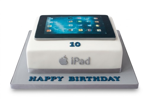 White square birthday cake with an edible iPad on top, Apple logo, "iPad" text, and a custom age number.