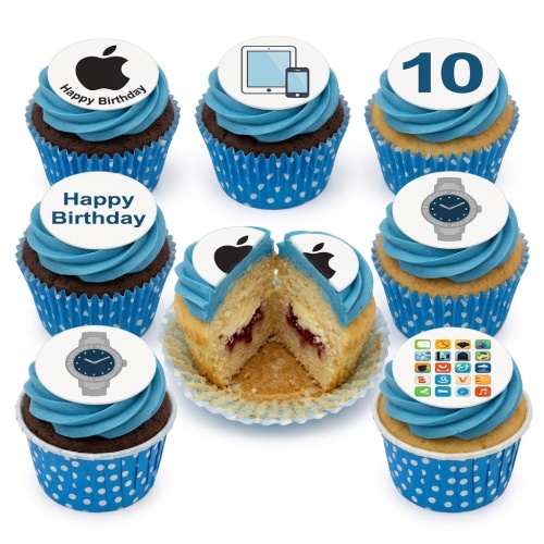 Blue frosted cupcakes with edible tech-themed toppers, including a brand logo, mobile devices, a watch, and app icons, with a custom age topper and a 'Happy Birthday' message.