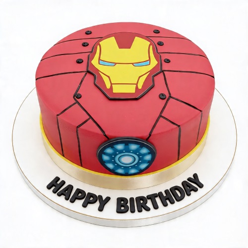 Round red Iron Man birthday cake with yellow mask, blue arc reactor, and 'Happy Birthday' message on board.