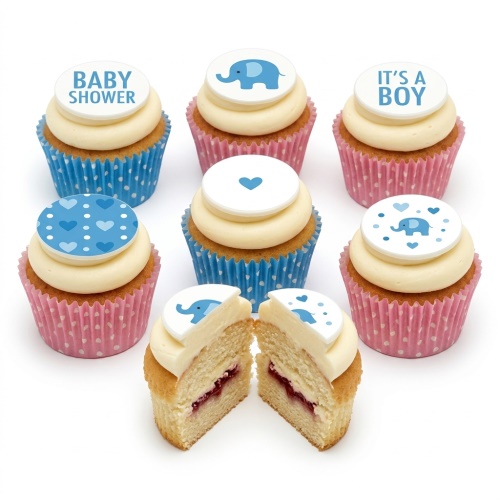 Baby shower cupcakes with blue elephant and 'It's a Boy' fondant toppers on cream frosting.