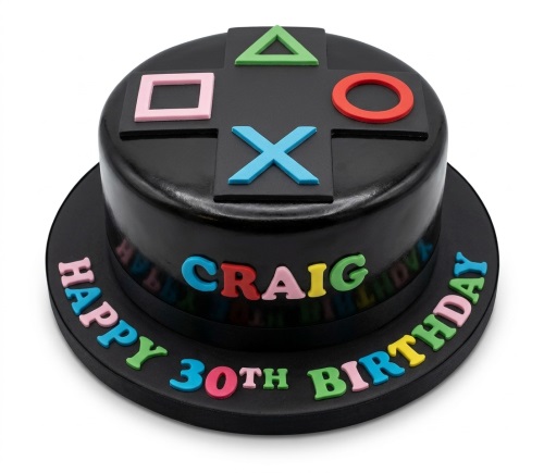 Black round gaming birthday cake with colourful console controller symbols on top and space for custom name and age message.
