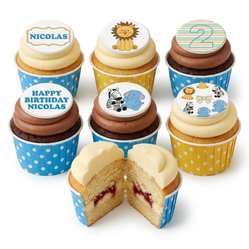 Assortment of jungle animal themed birthday cupcakes with custom age and name toppers.