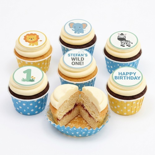 A selection of jungle animal and 'Wild One' themed 1st birthday cupcakes with blue and yellow cases.
