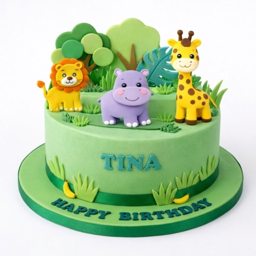 Green jungle animal birthday cake with fondant lion, hippo, giraffe, trees, and grass.