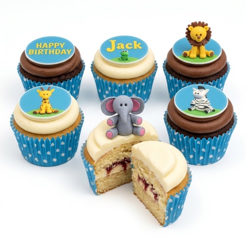 Assorted jungle animal themed cupcakes with lion, giraffe, zebra, elephant, and frog toppers, some with 'Happy Birthday' and a custom name.