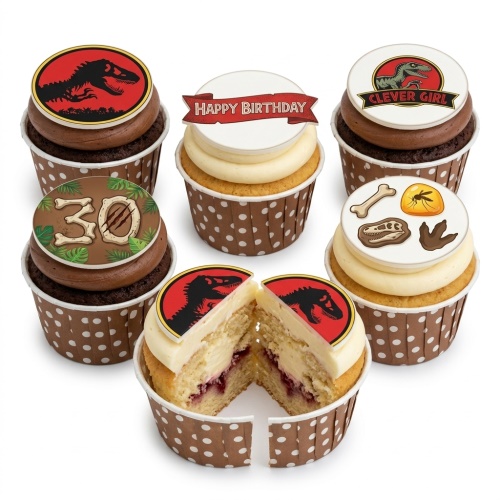 Assortment of Jurassic Park themed cupcakes with dinosaur logos, fossil designs, and a custom age topper.