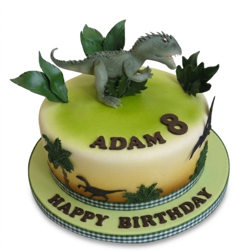 Green and yellow dinosaur birthday cake with a 3D dinosaur, leaves, and custom age topper.