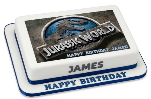 Square white fondant cake with an edible Jurassic World logo on top, blue ribbon trim.