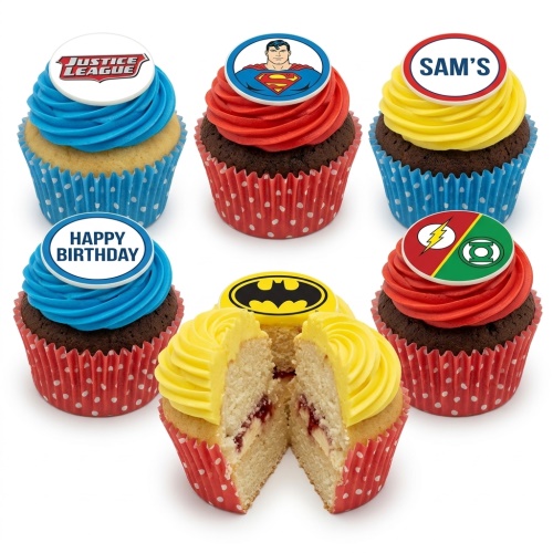 A selection of Justice League superhero themed cupcakes with red, blue, and yellow frosting and edible character toppers.